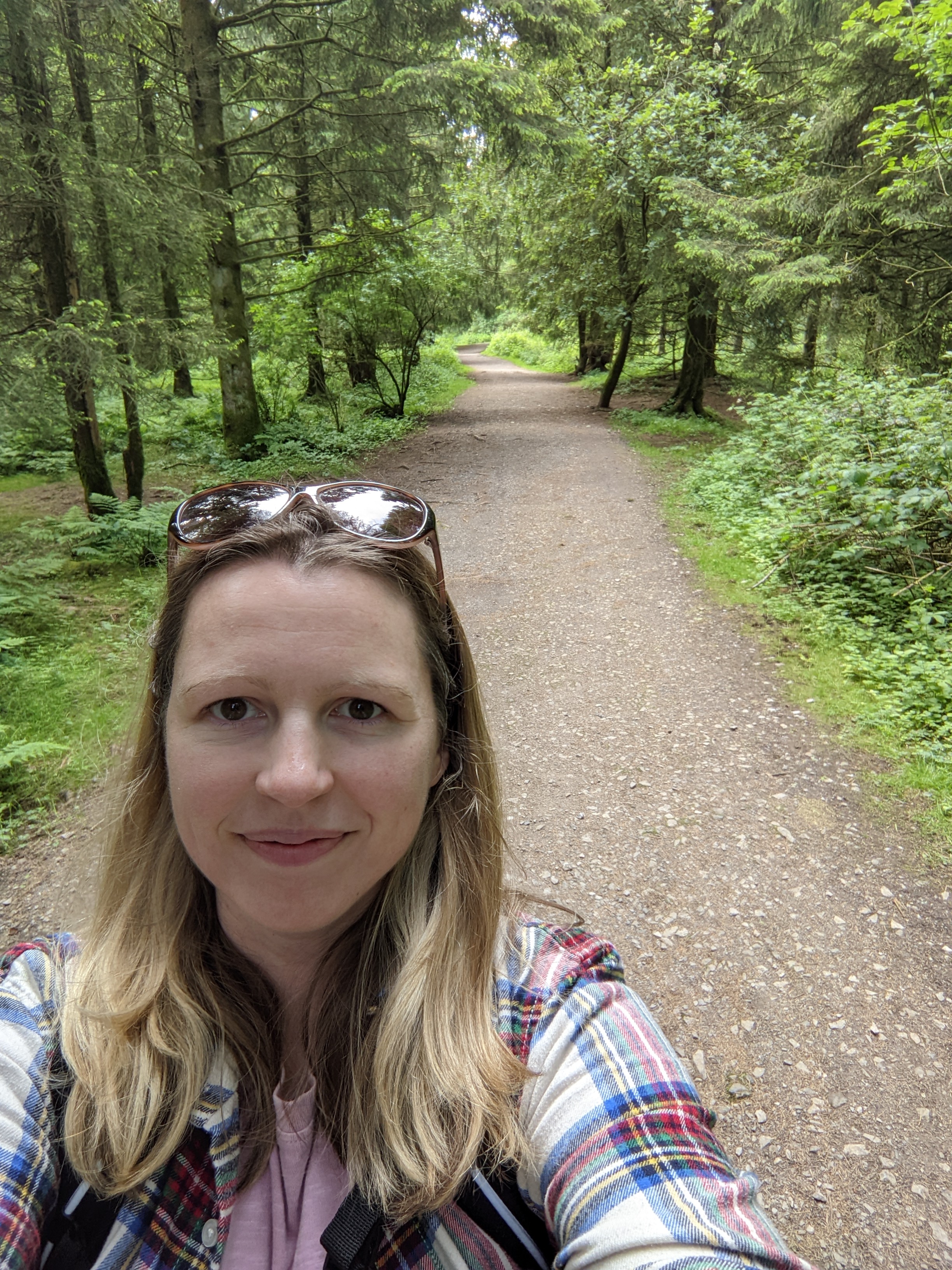 Lindsay taking a selfie with the woods behind her